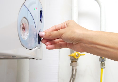 hand adjusts boiler settings